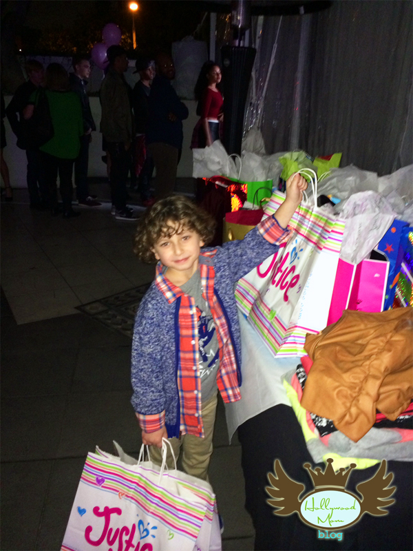 In lieu of gifts, Guests like August Maturo bring clothing for the charity "Threads for Teens" 